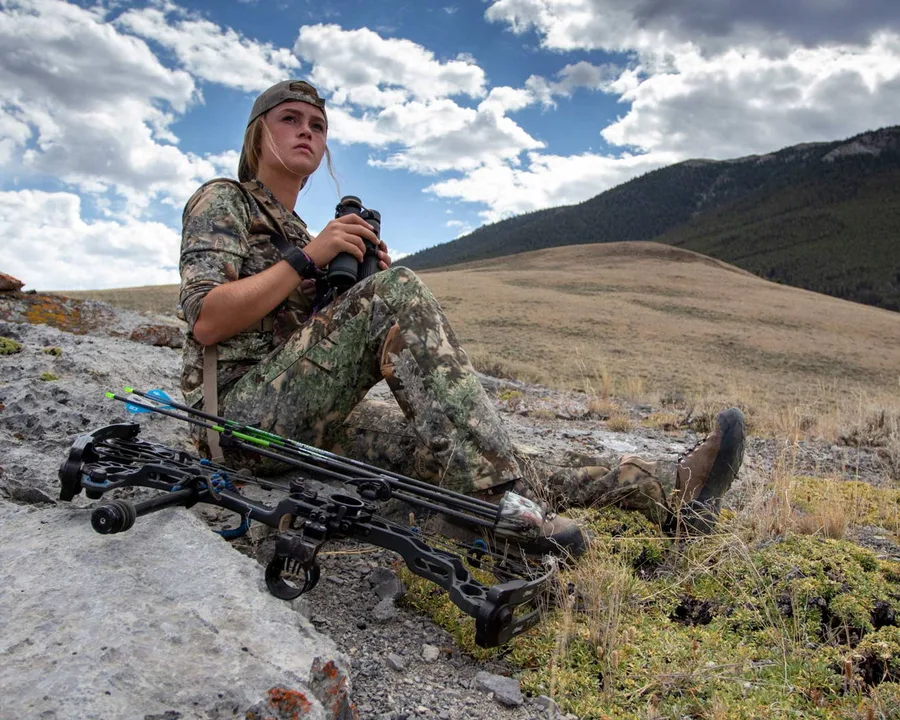Hunter wearing Kings Camo while glassing across open country